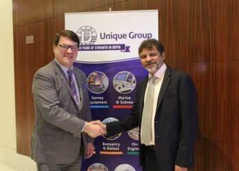 Kongsberg Marine’s Konrad Mech shakes hands with Harry Gandhi, chief executive of Unique Group