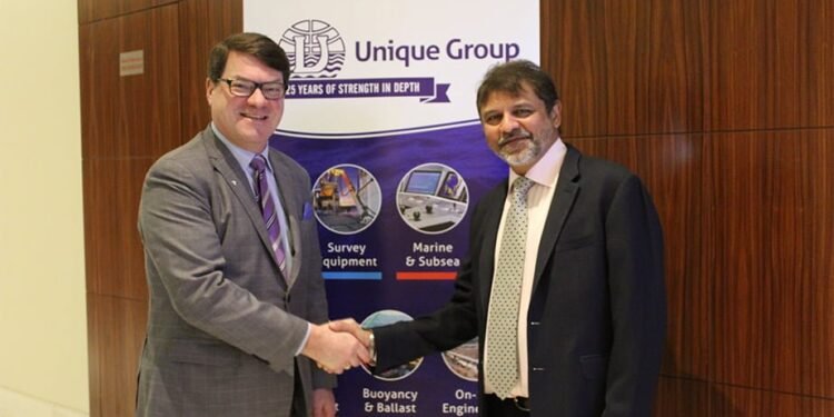 Kongsberg Marine’s Konrad Mech shakes hands with Harry Gandhi, chief executive of Unique Group