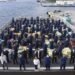 The Coast Guard Cutter Hamilton (WMSL 753) crew stands amongst approximately 11,500 pounds of cocaine and approximately 17,000 pounds of marijuana, Aug. 27