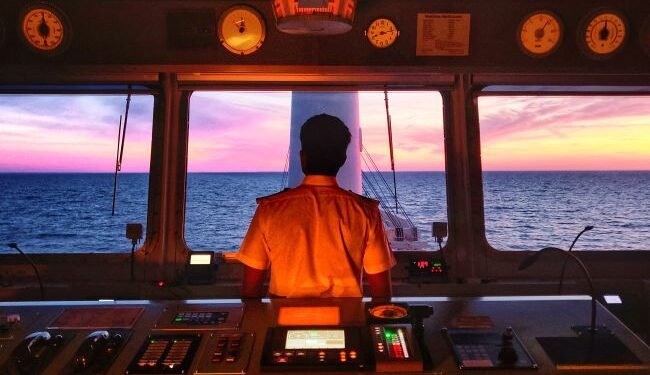 Anglo-Easter Univan Group Seafarer Standing At Bridge