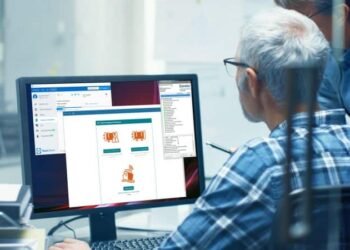 Two Senior Architectural Engineers Working With Green Screen on a Personal Computer. They Actively Discuss Various Plans and Schemes. Great Template for Mock up. computer - internet of things - iot remote access - representation