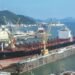 A large tanker ship is being renovated in shipyard