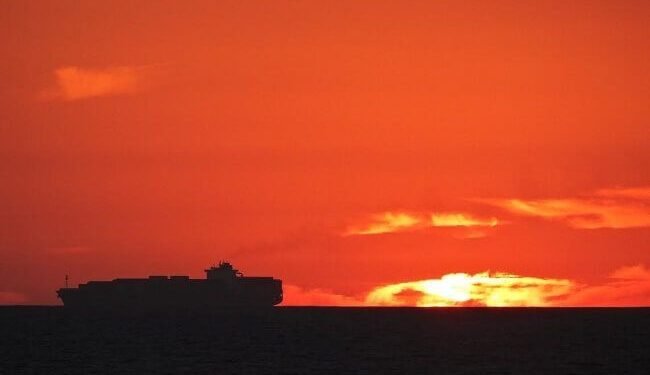 silhouette sunset container ship