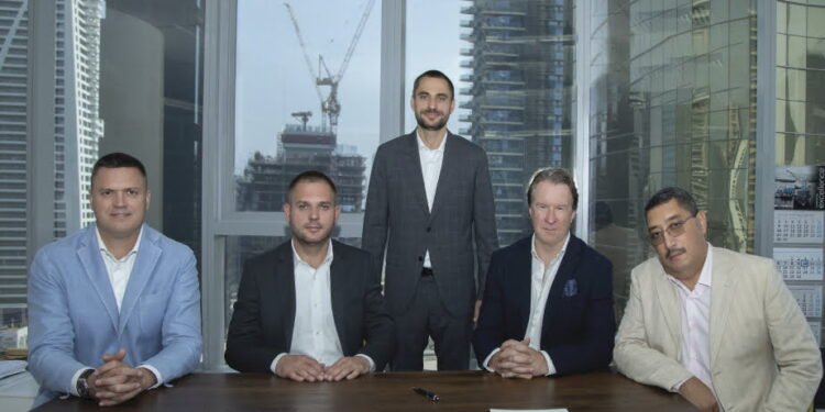 Mycrane founder Andrei Geikalo, standing, is pictured with new franchise partners following the signing of partnership agreements in Dubai