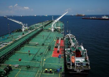 A bunker vessel prepares to supply fuel to Hin Leong's Pu Tuo Shan VLCC supertanker in the waters off Jurong Island in Singapore