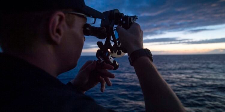 USMMA Cadet using a sextant for celestial navigation