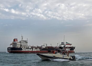 A boat of Iranian Revolutionary Guard sails next to Stena Impero, a British-flagged vessel owned by Stena Bulk, at Bandar Abbas port