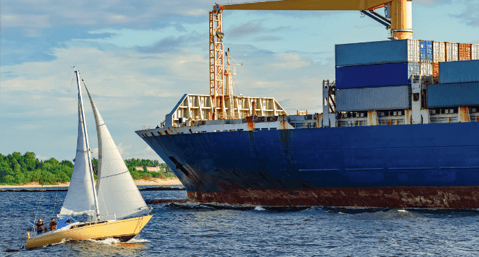boat near container ship