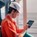 Marine chief officer or captain on deck of vessel or ship watching digital tablet. Internet and home connection at sea.