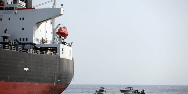 UAE Navy boats next to Al Marzoqah Saudi Arabia tanker are seen off the Port of Fujairah
