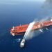 An Iranian navy boat tries to stop the fire of an oil tanker after it was attacked in the Gulf of Oman