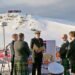 Ship Captain Will Whatley reads the nuptials to Eric (left) and Steve, with staff from Rothera Research Station in the background.