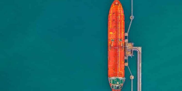 Class NK Calculates Vessels' CARBON DIOXIDE Emissions For Sustainability-Linked Loan Oil/Chemical tanker ship loading in port, Tanker ship under cargo operation logistic import export business and transportation, Aerial view.