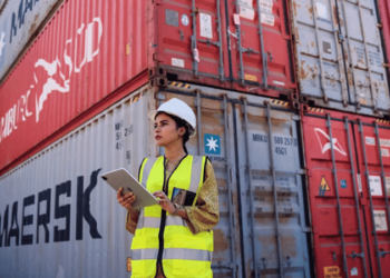 Lady port worker with maersk containers