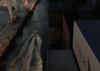 Watch: Crazy Dude Brings Boat Between Ship and Pier During Docking