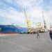 FILE PHOTO - People walk past a ship docked at the Red Sea port of Hodeidah