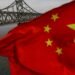 Trump Warns China After Seoul Seizes HK-Flagged Tanker Selling Oil To North Korea A Chinese flag is seen in front of the Friendship bridge over the Yalu River connecting the North Korean town of Sinuiju and Dandong in China