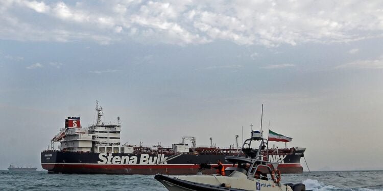A boat of Iranian Revolutionary Guard sails next to Stena Impero, a British-flagged vessel owned by Stena Bulk, at Bandar Abbas port