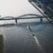 a ship passes below a bridge on the Rhine River