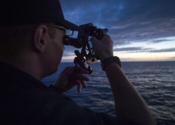 USMMA Cadet using a sextant for celestial navigation