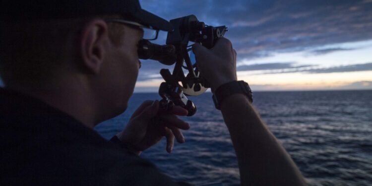USMMA Cadet using a sextant for celestial navigation