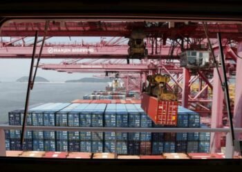 File photo of a crane carrying a container from a ship of Hanjin Shipping at Hanjin container terminal at the Busan New Port in Busan