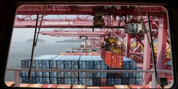 File photo of a crane carrying a container from a ship of Hanjin Shipping at Hanjin container terminal at the Busan New Port in Busan