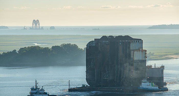 tugs remove section of wreck