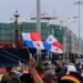 People wave Panama flags as they wait for the Chinese COSCO container vessel named Andronikos to navigate through the Agua Clara locks during the first ceremonial pass through the newly expanded Panama Canal, June 26, 2016. REUTERS/Carlos Jasso TPX IMAGES OF THE DAY
