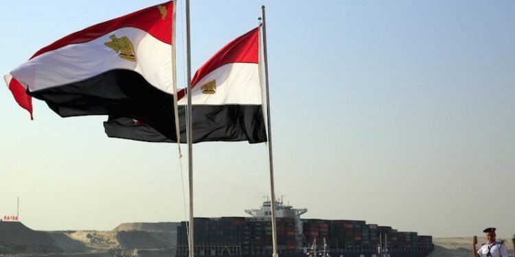 A cargo container ship crosses new section of Suez Canal after opening ceremony of new Suez Canal, in Ismailia