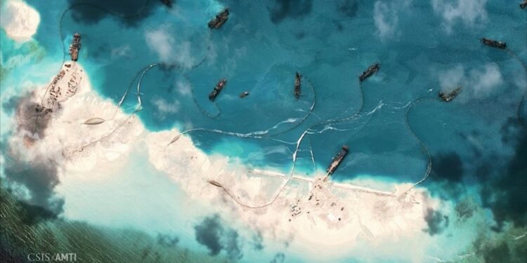 Satellite image of dredgers depositing sand on the northern rim of the Mischief Reef